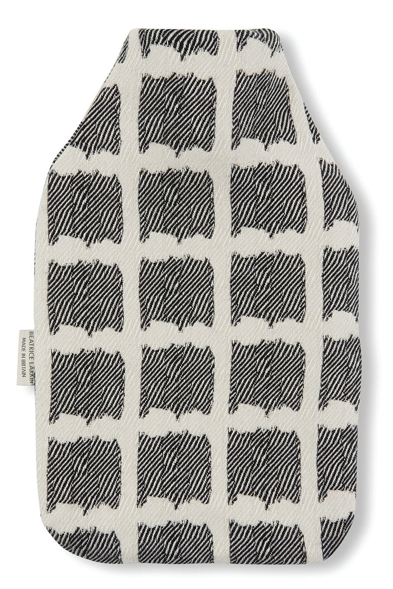 Beatrice Larkin weaved merino wool hot water bottle in Ikat black and cream pattern.