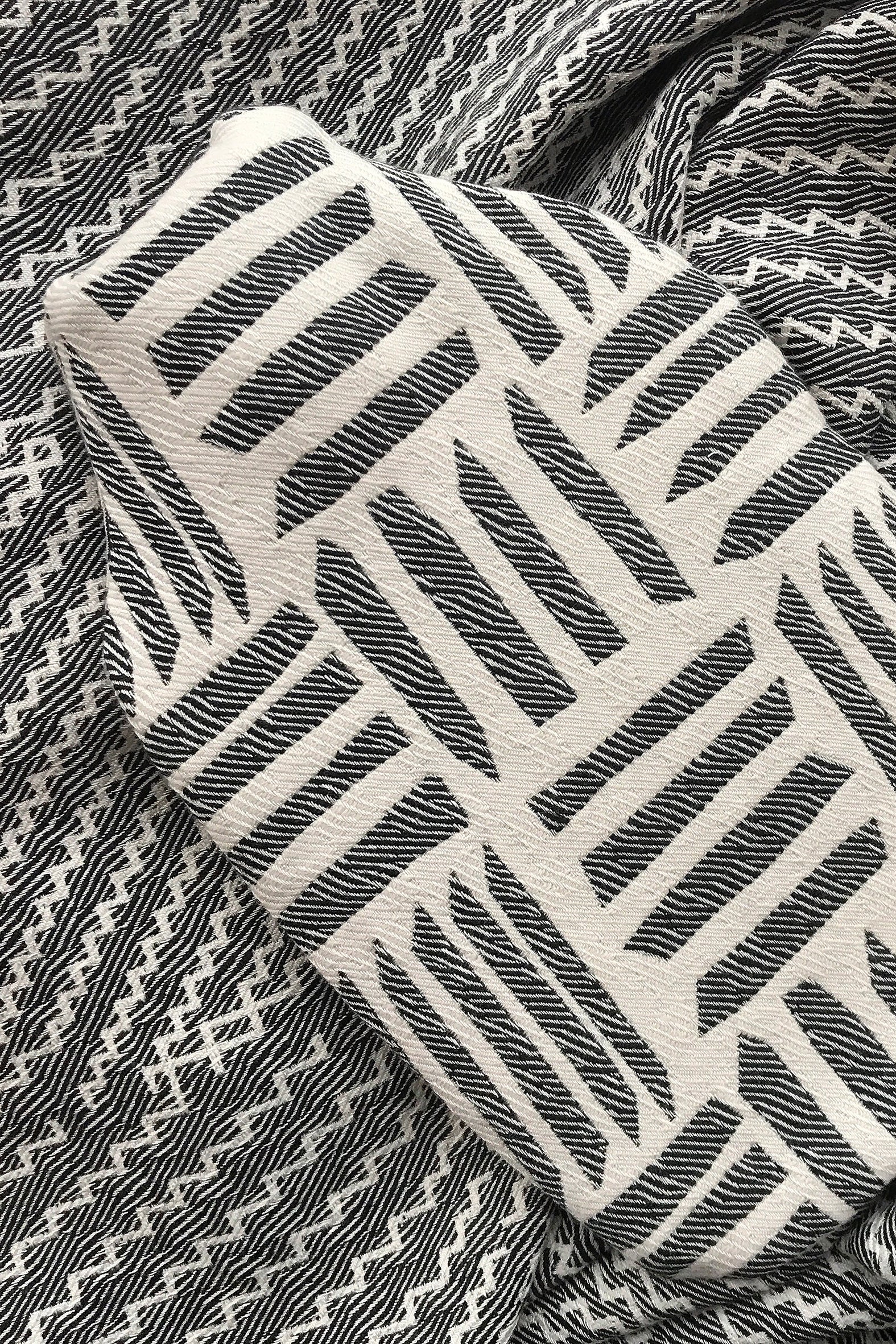 Beatrice Larkin weaved merino wool hot water bottle in cut light black and cream pattern.