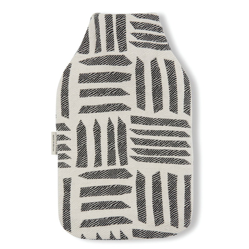 Beatrice Larkin weaved merino wool hot water bottle in cut light black and cream pattern.