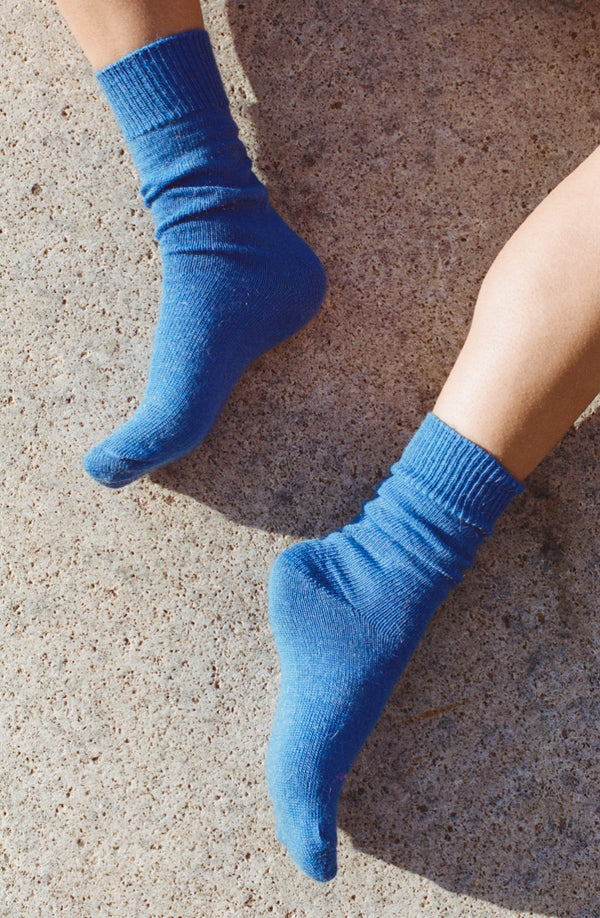 styled shoot floor image of feet wearing Cobalt blue mohair Oaken socks available at Ash, Falmouth