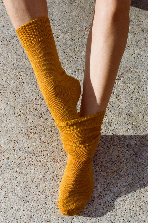 styled shoot floor image of feet wearing marigold mohair Oaken socks available at Ash, Falmouth