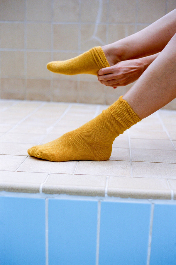 styled shoot pool image of feet wearing marigold mohair Oaken socks available at Ash, Falmouth