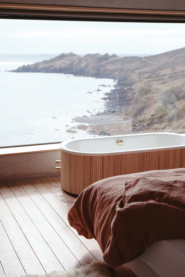 styled shot of bed with bedding in cafe creme, coastal bedroom, plaster colour for Ondine Ash Falmouth