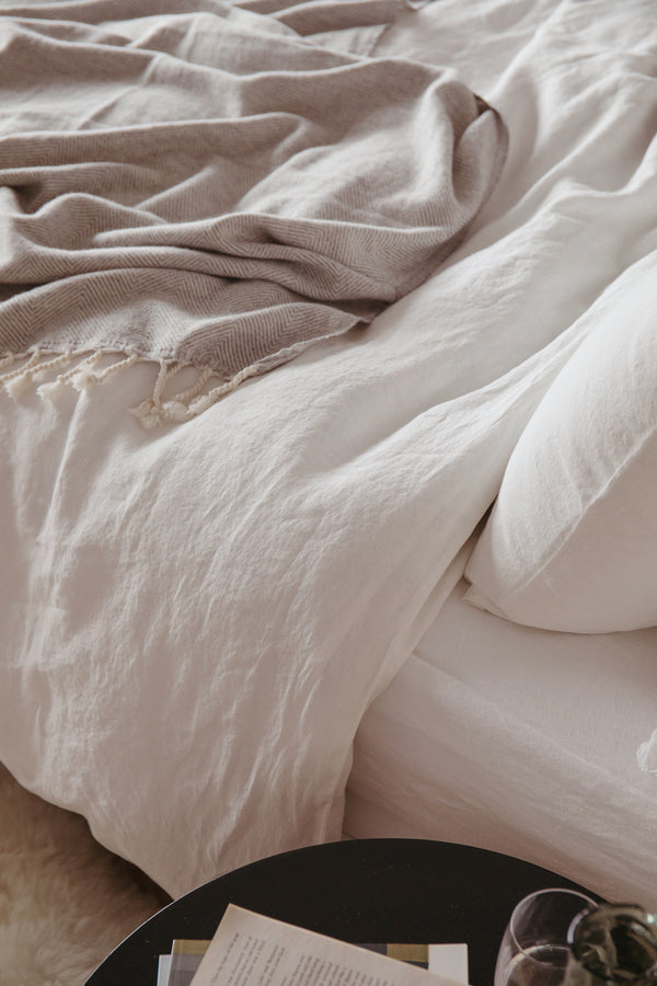 styled shot of unmade bed with bedding in cafe creme, plaster colour for Ondine Ash Falmouth