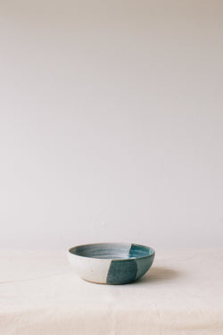 Handmade ceramic bowl by Liz Vidal. This bowl is the perfect size for breakfast, salads or soups. Liz uses different tones of blue glaze to dip her bowls to create an abstract landscape design.