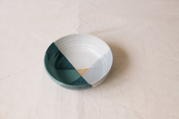 Handmade ceramic bowl by Liz Vidal. This bowl is the perfect size for breakfast, salads or soups. Liz uses different tones of blue glaze to dip her bowls to create an abstract landscape design. 