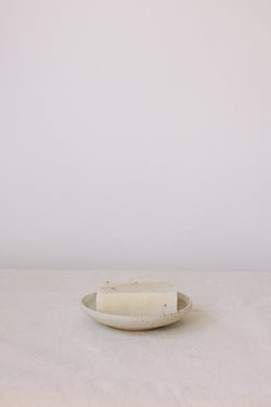 Handmade ceramic soap dish by Liz Vidal. This incense holder is a simple round shape and is finished with 3 holes and a small foot plate to allow the soap to drain. Liz has used a plain white glaze which shows small specs from the clay though it, giving it a beautiful natural finish.